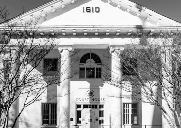 A black and white view of the historic courthouse facade in Hampton, Virginia