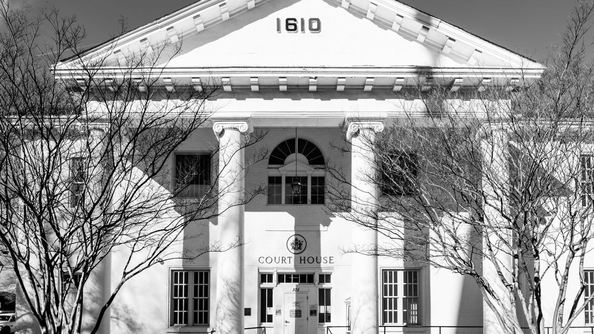 A black and white view of the historic courthouse facade in Hampton, Virginia