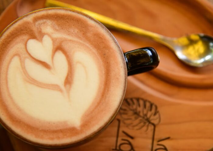 Latte art coffee on a wooden tray in a cafe