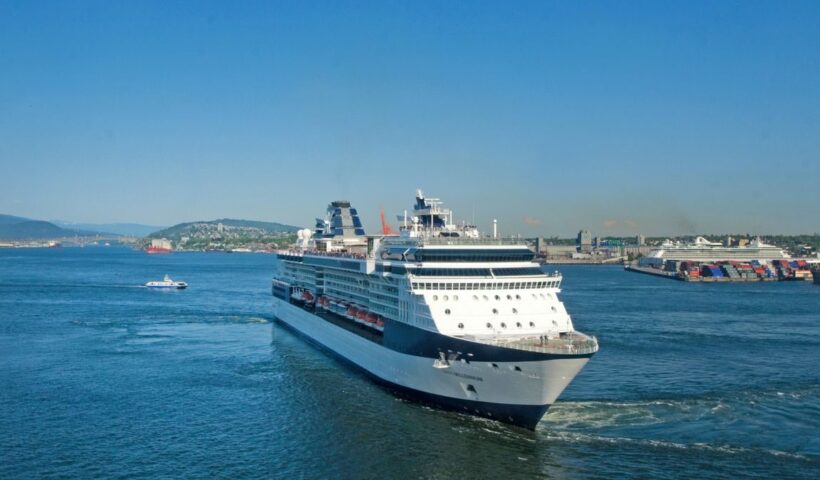 A large cruise ship sailing through calm waters under a clear blue sky