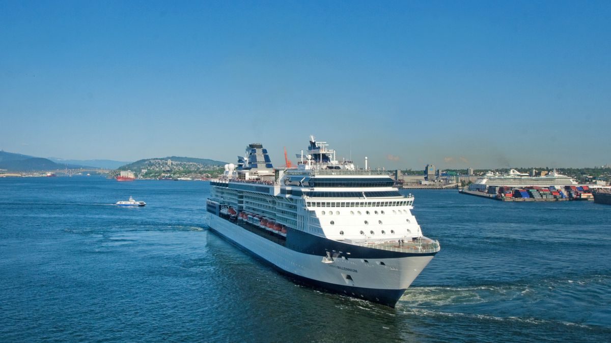 A large cruise ship sailing through calm waters under a clear blue sky