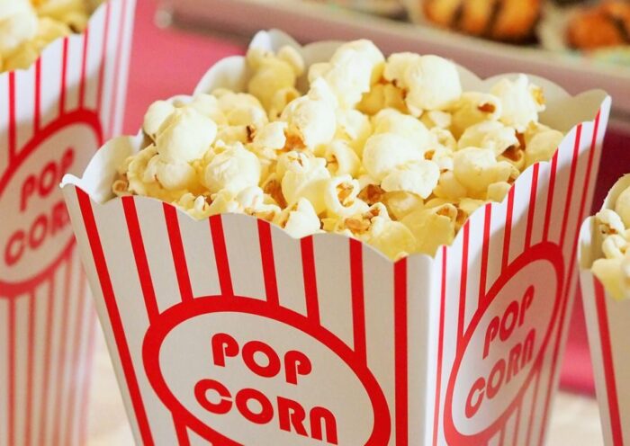 Close-up of gourmet popcorn in classic red and white striped boxes