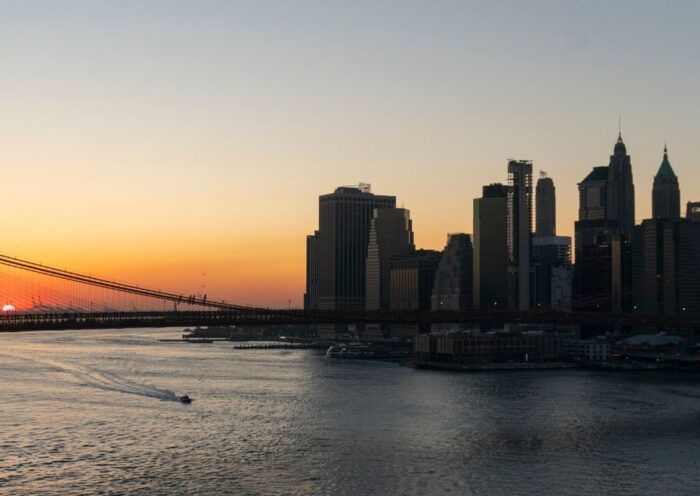 Stunning view of Brooklyn Bridge and Manhattan skyline captured during sunset over the New York City waterfront