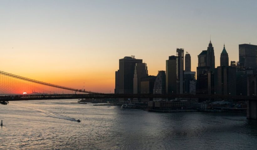 Stunning view of Brooklyn Bridge and Manhattan skyline captured during sunset over the New York City waterfront
