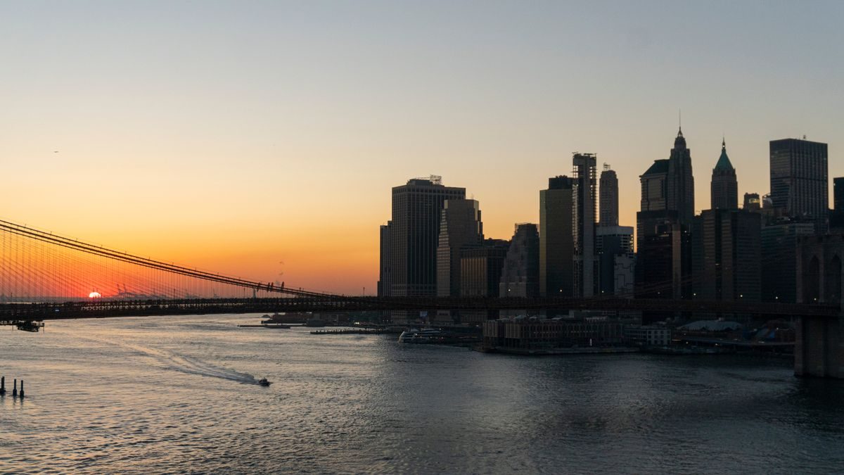 Stunning view of Brooklyn Bridge and Manhattan skyline captured during sunset over the New York City waterfront