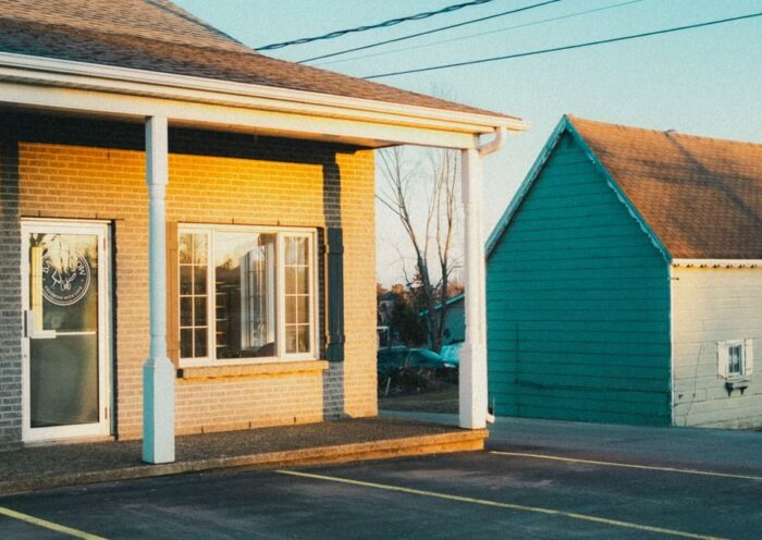 A serene image of suburban buildings and parking lot during golden hour