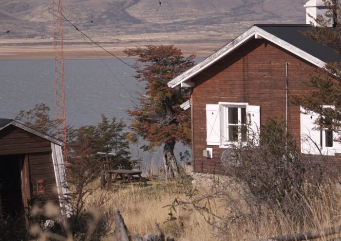 Rustic wooden cabin by a lake in the countryside
