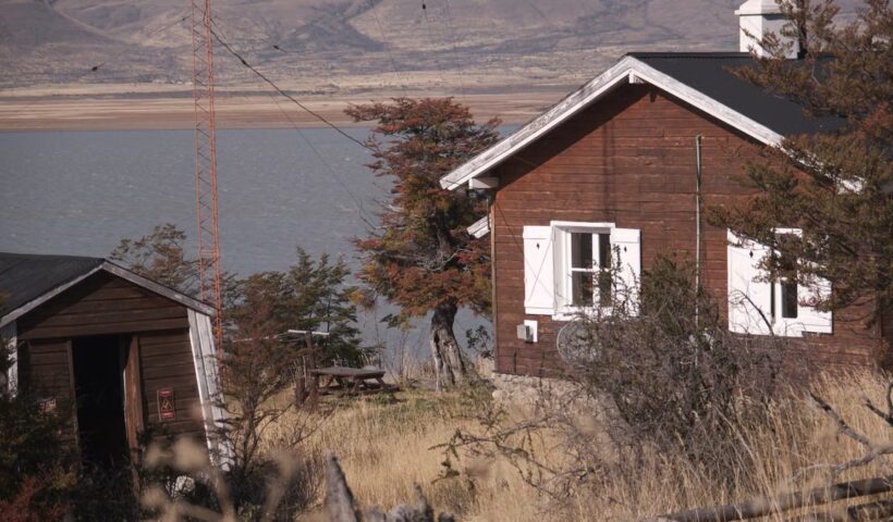 Rustic wooden cabin by a lake in the countryside