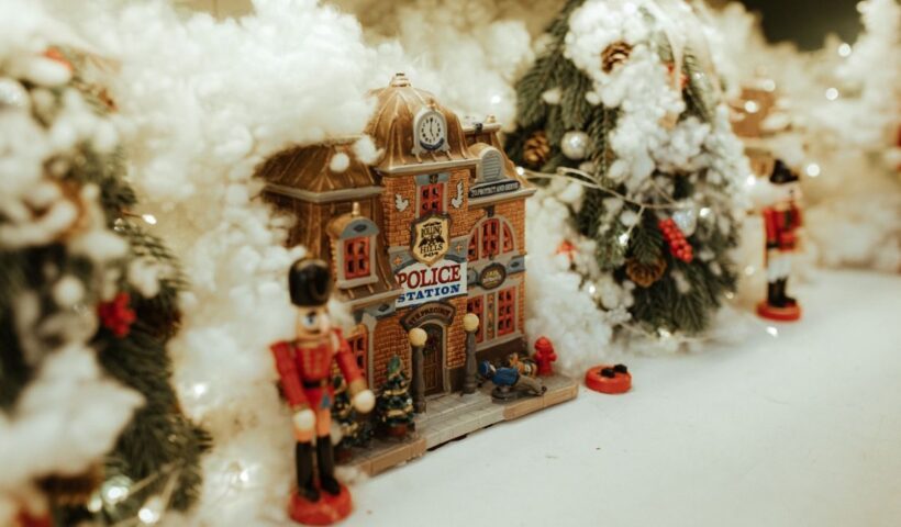 Miniature Christmas village with snow and nutcracker