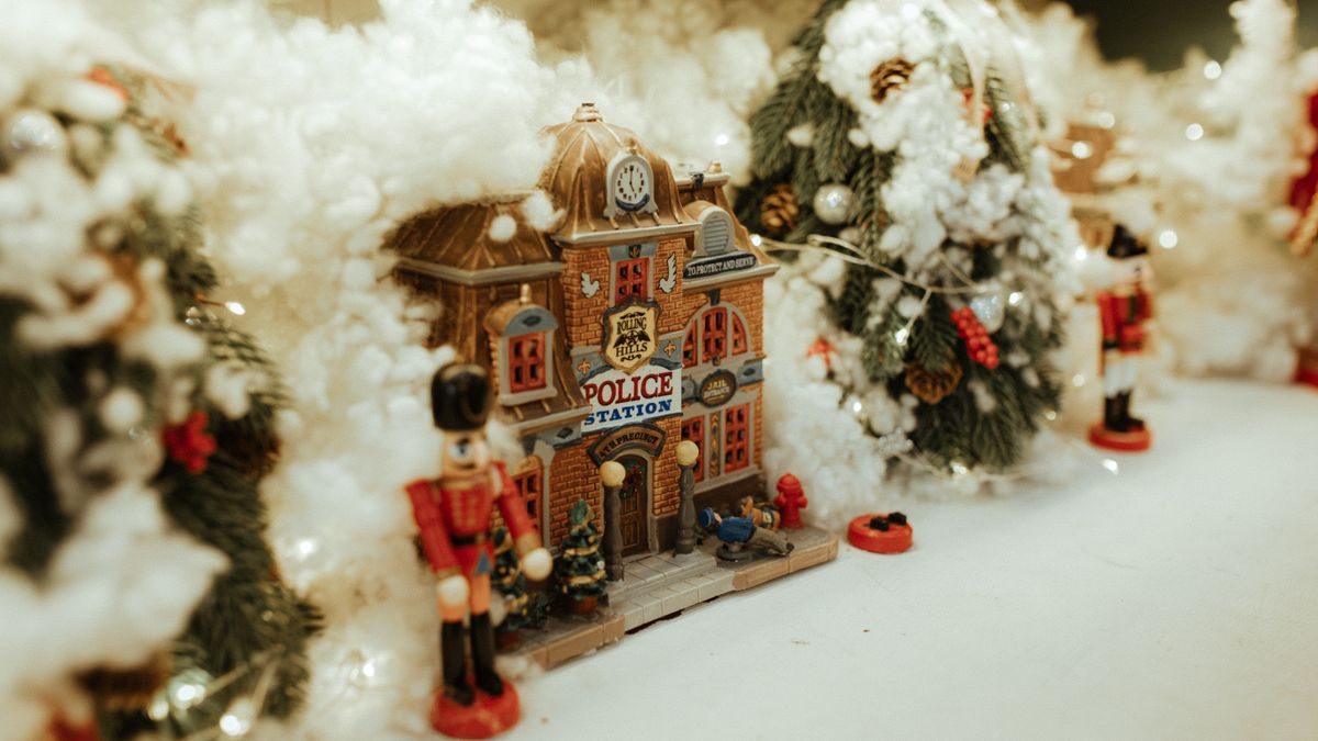 Miniature Christmas village with snow and nutcracker