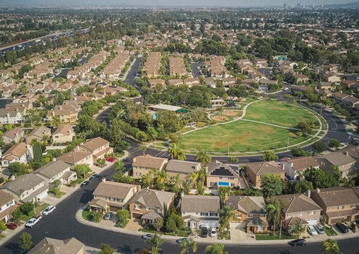 Aerial view of a suburban neighborhood with houses and a park