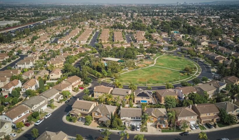 Aerial view of a suburban neighborhood with houses and a park